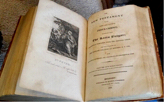 An open book with a picture of a person

Description automatically generated